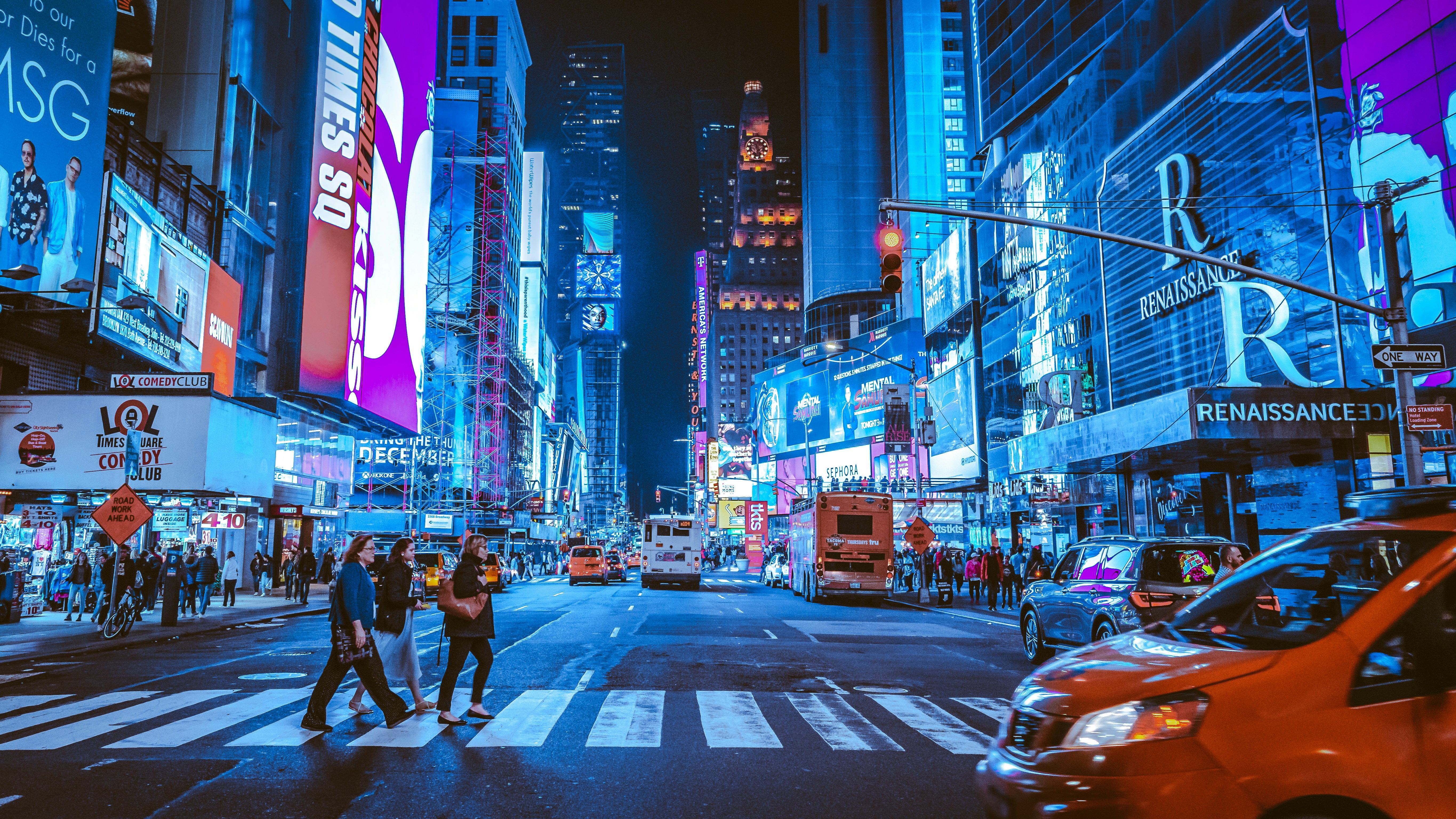 NYC Times Square at night with architectural lighting and urban energy